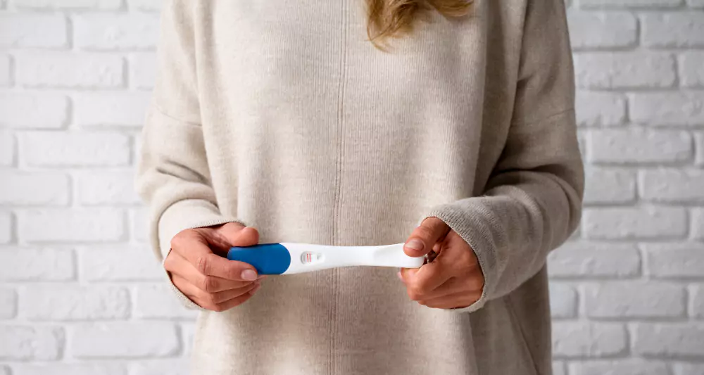 Woman Holding Positive Pregnancy Test