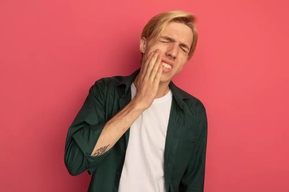 Young Guy Putting Hand On Aching Tooth